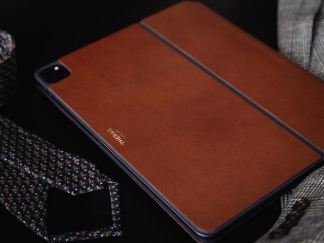 Tablet leather cover with thermoplastic adhesive